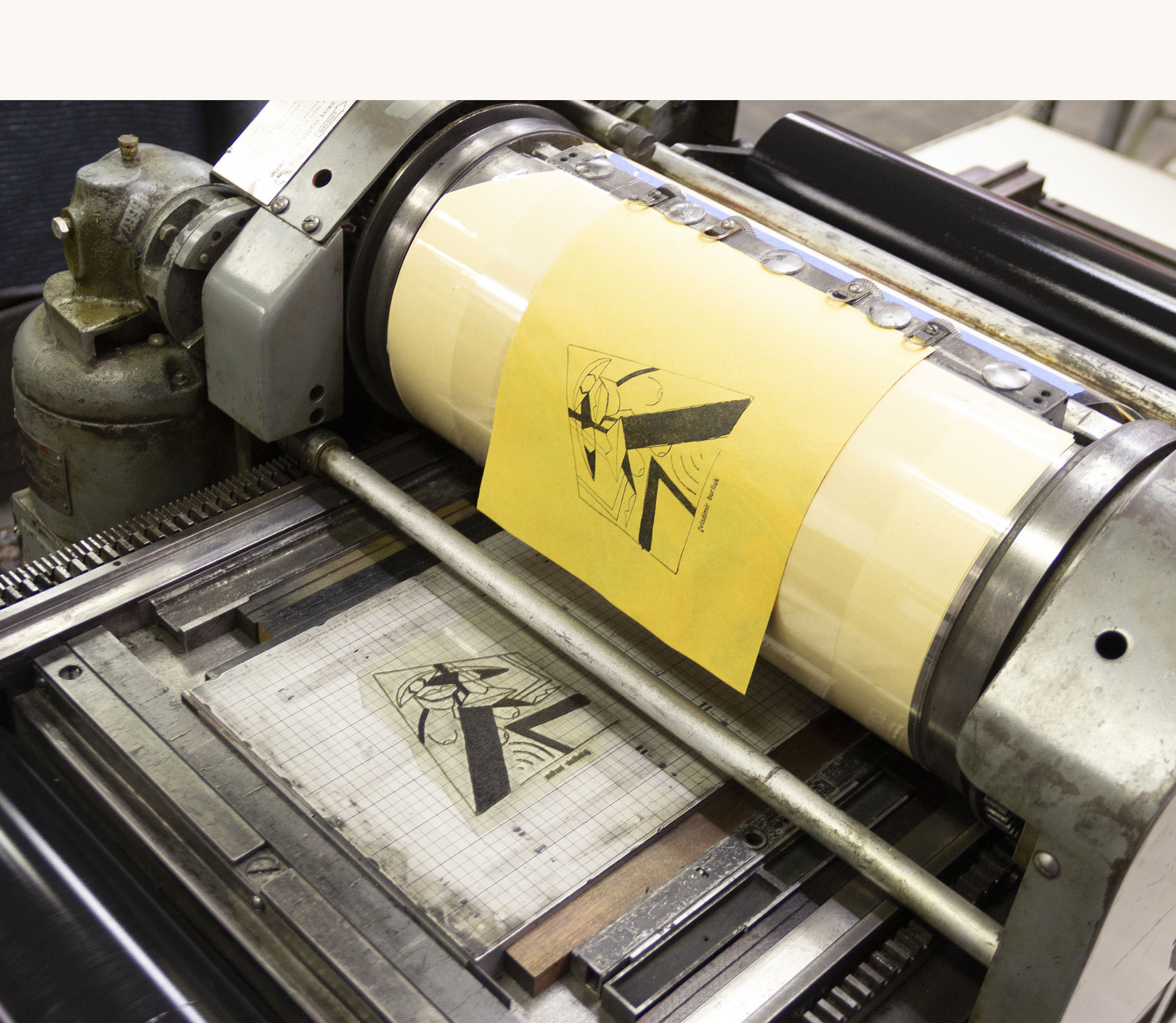 Printing the frontispiece, showing a printing press and printing plate.